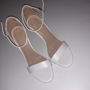 Woman’s white single strap heels
